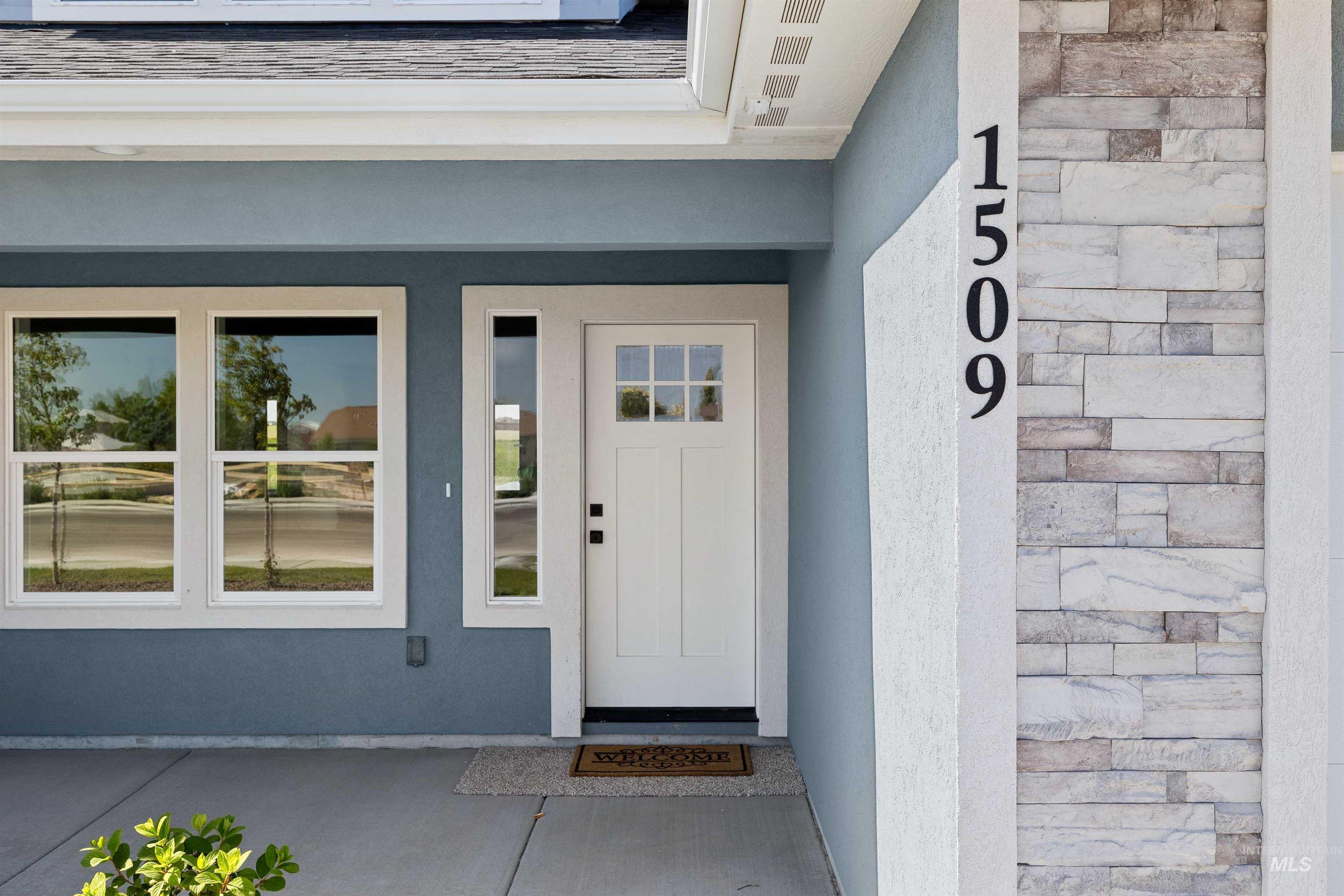 Property entrance featuring stone siding and stucco siding