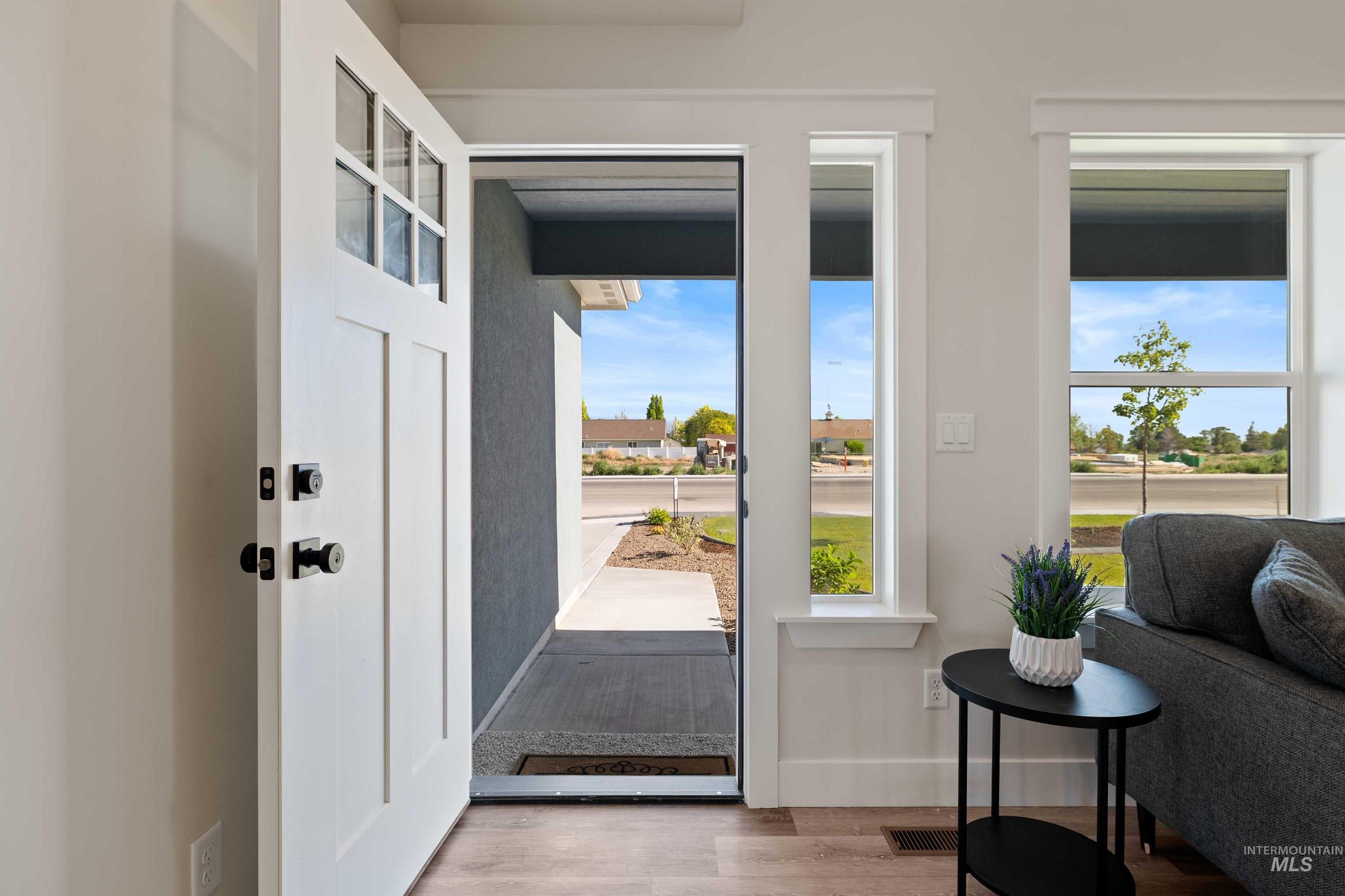 Entryway with wood finished floors and baseboards