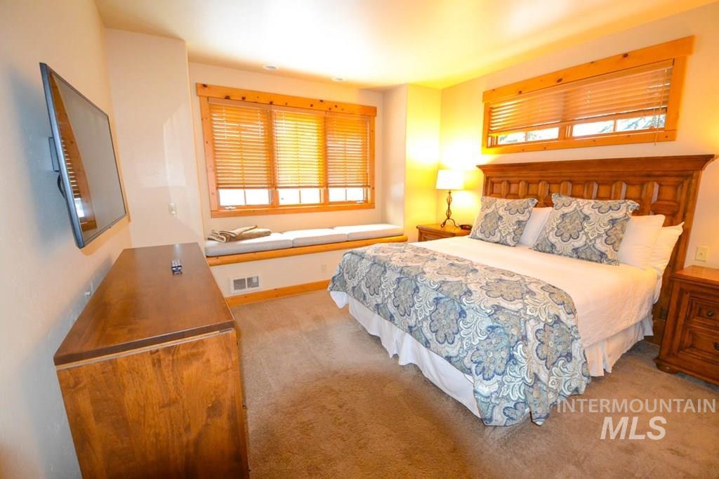 Bedroom with light carpet