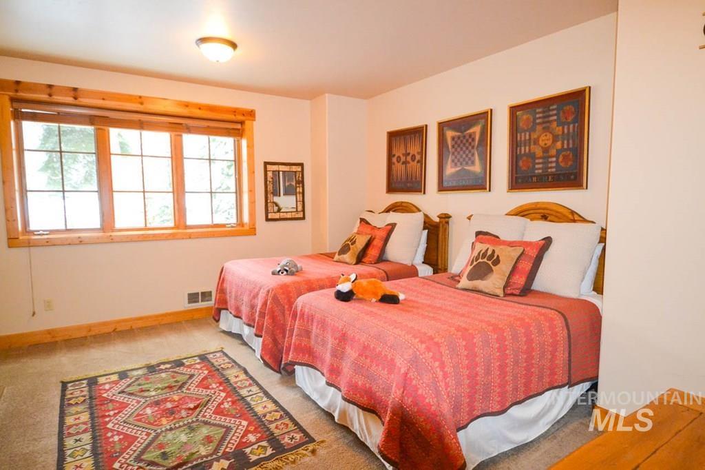 Carpeted bedroom with baseboards