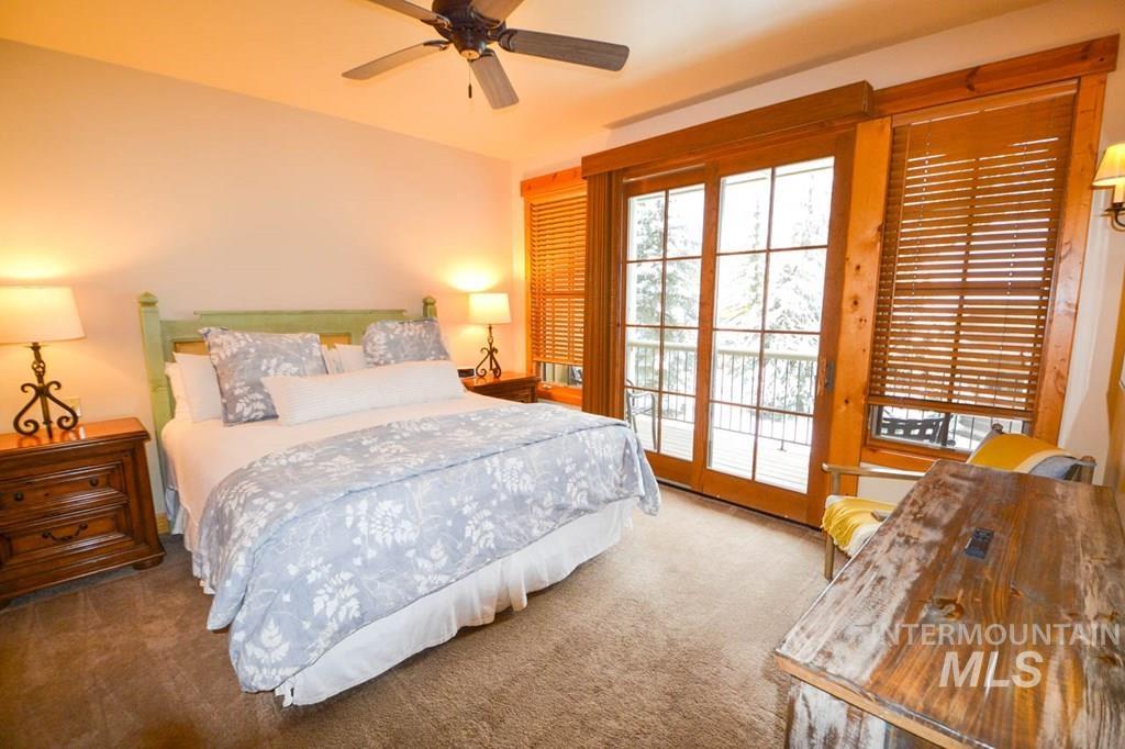 Bedroom featuring access to outside, carpet floors, and ceiling fan