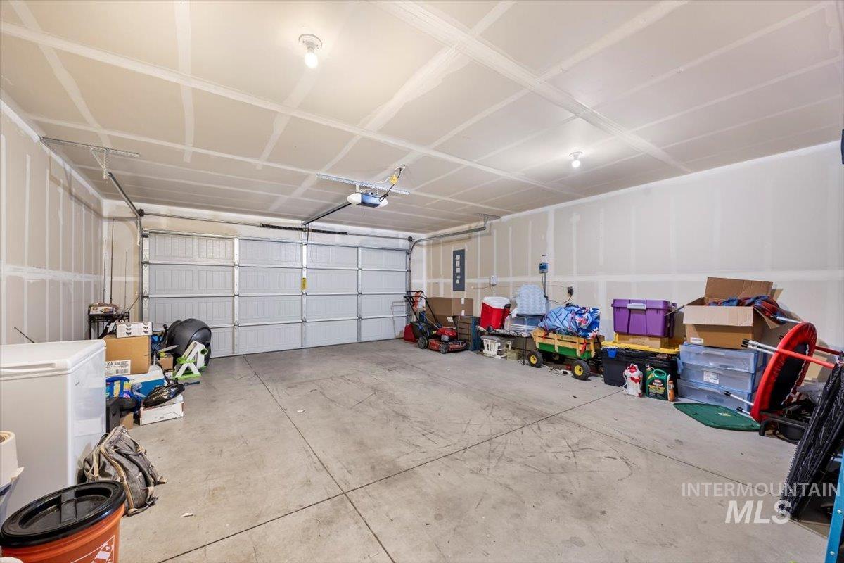 Garage with refrigerator and electric panel