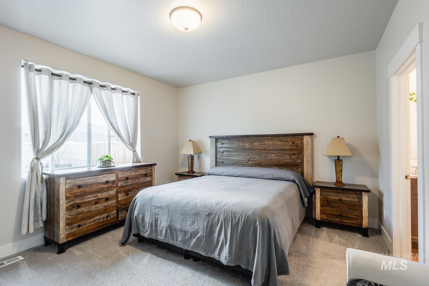 Bedroom with light colored carpet