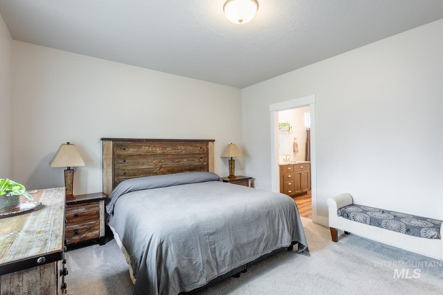 Carpeted bedroom featuring connected bathroom
