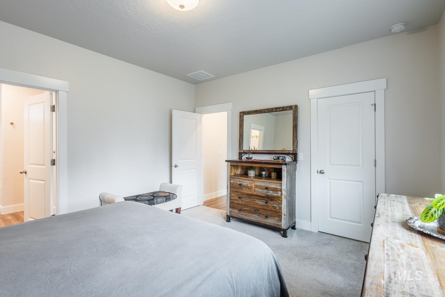 Bedroom featuring baseboards and light colored carpet