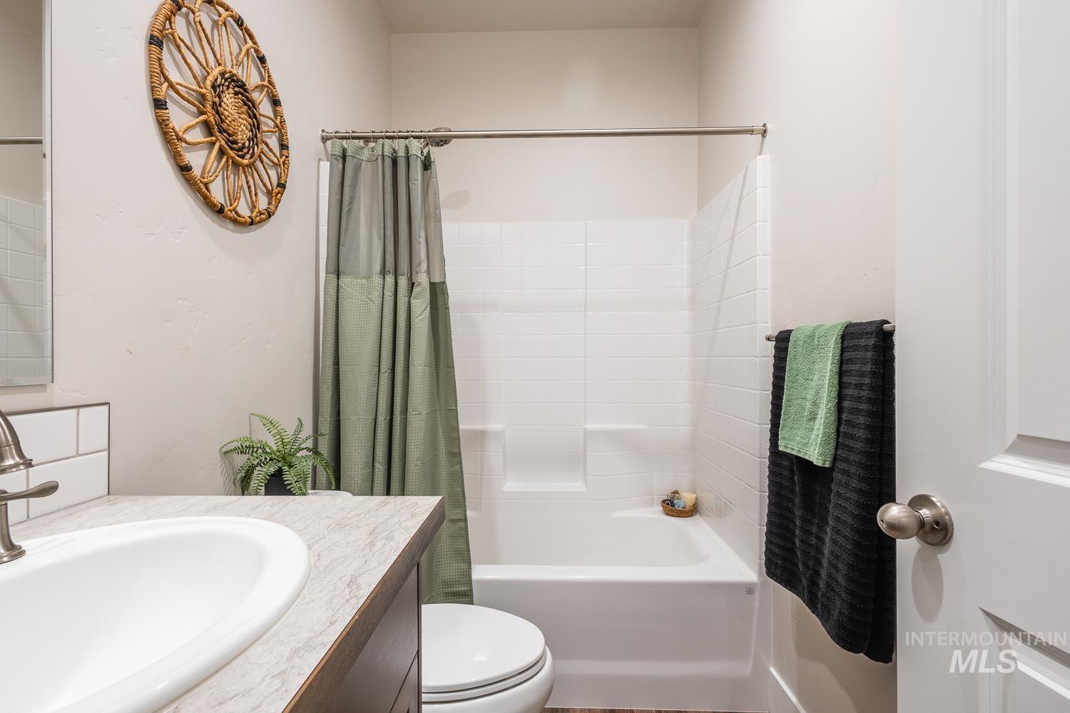 Full bathroom with shower / bath combination with curtain and vanity