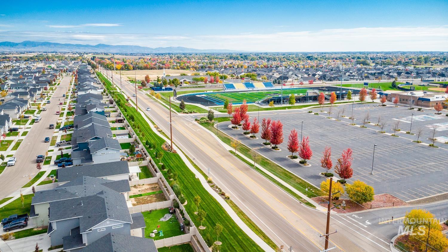 Aerial perspective of suburban area featuring a mountain backdrop