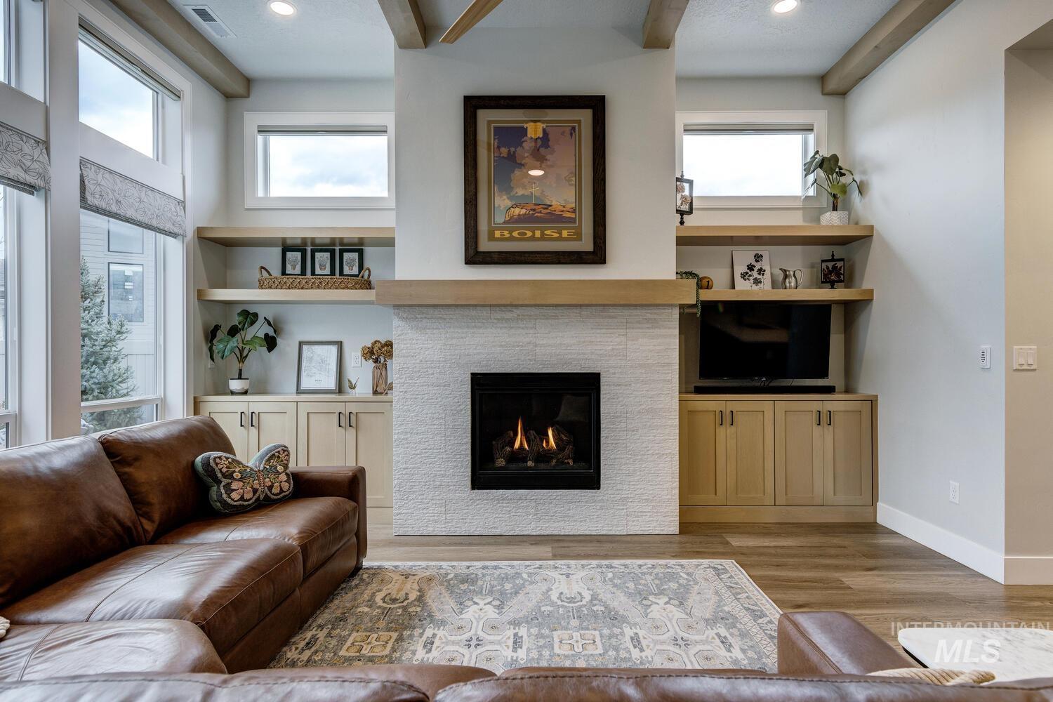 Living area featuring light wood-style floors, a tile fireplace, and recessed lighting