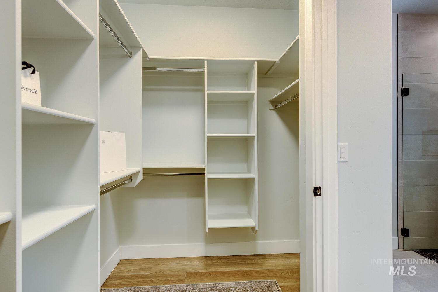 Spacious closet with light wood-style floors