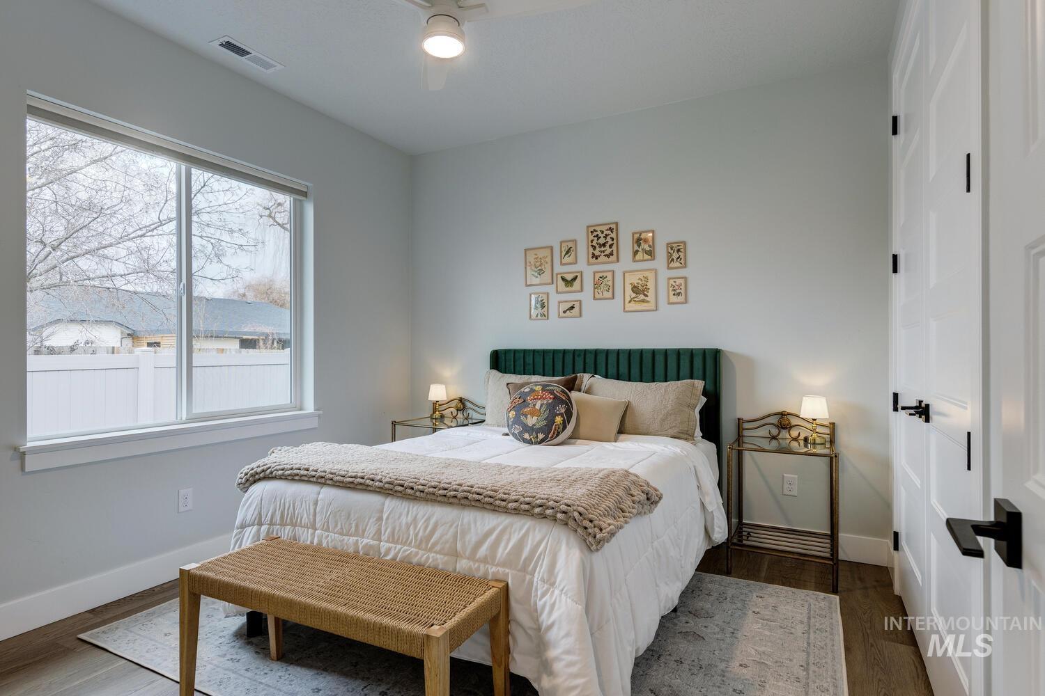 Bedroom with wood finished floors and ceiling fan