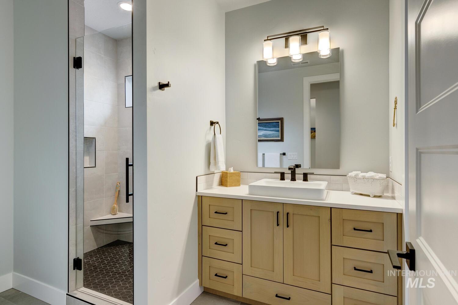 Bathroom with vanity and a shower stall