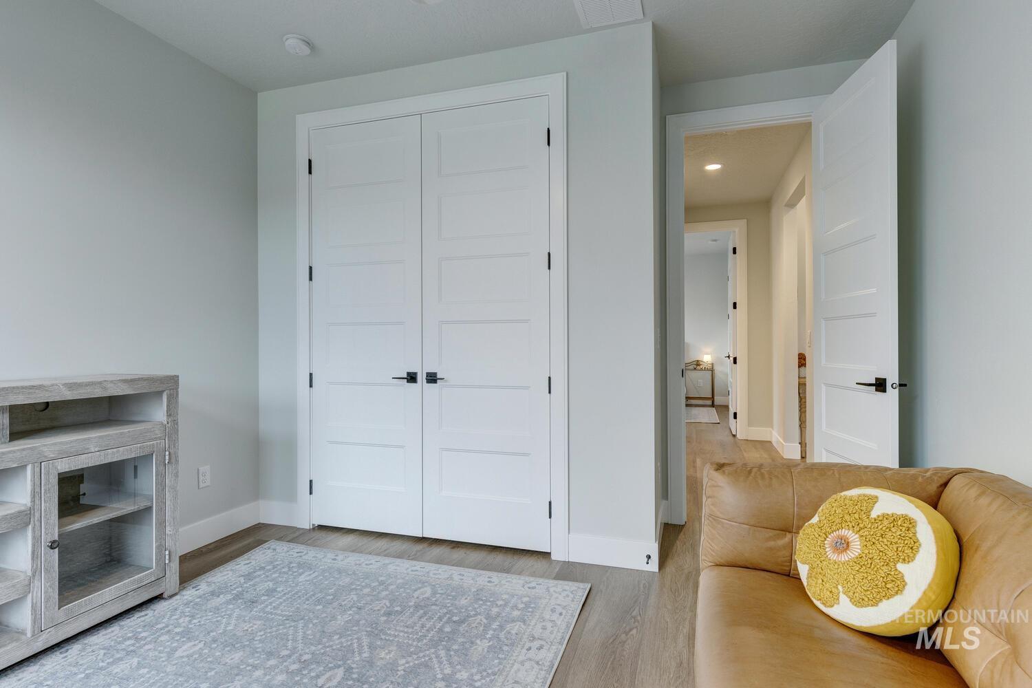 Sitting room featuring wood finished floors and baseboards