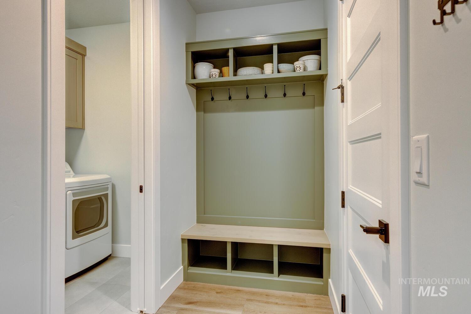 Mudroom featuring washer / clothes dryer and light wood-style floors