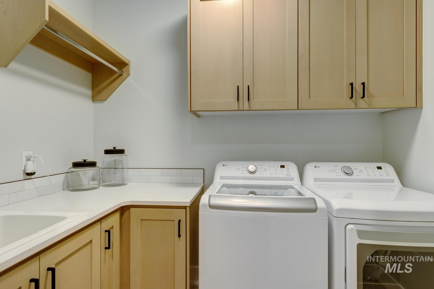 Washroom with washing machine and dryer and cabinet space