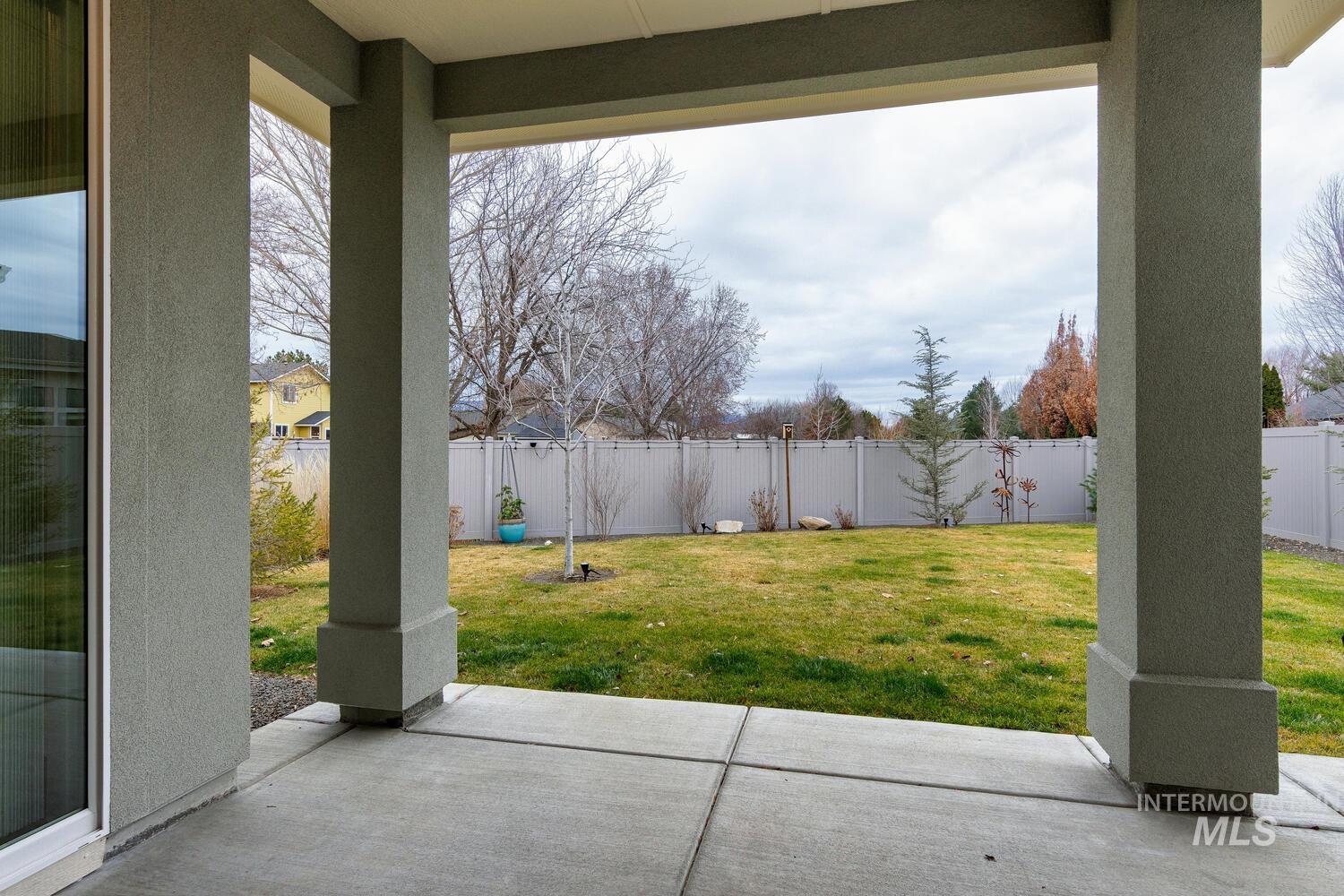 Fenced backyard featuring a patio