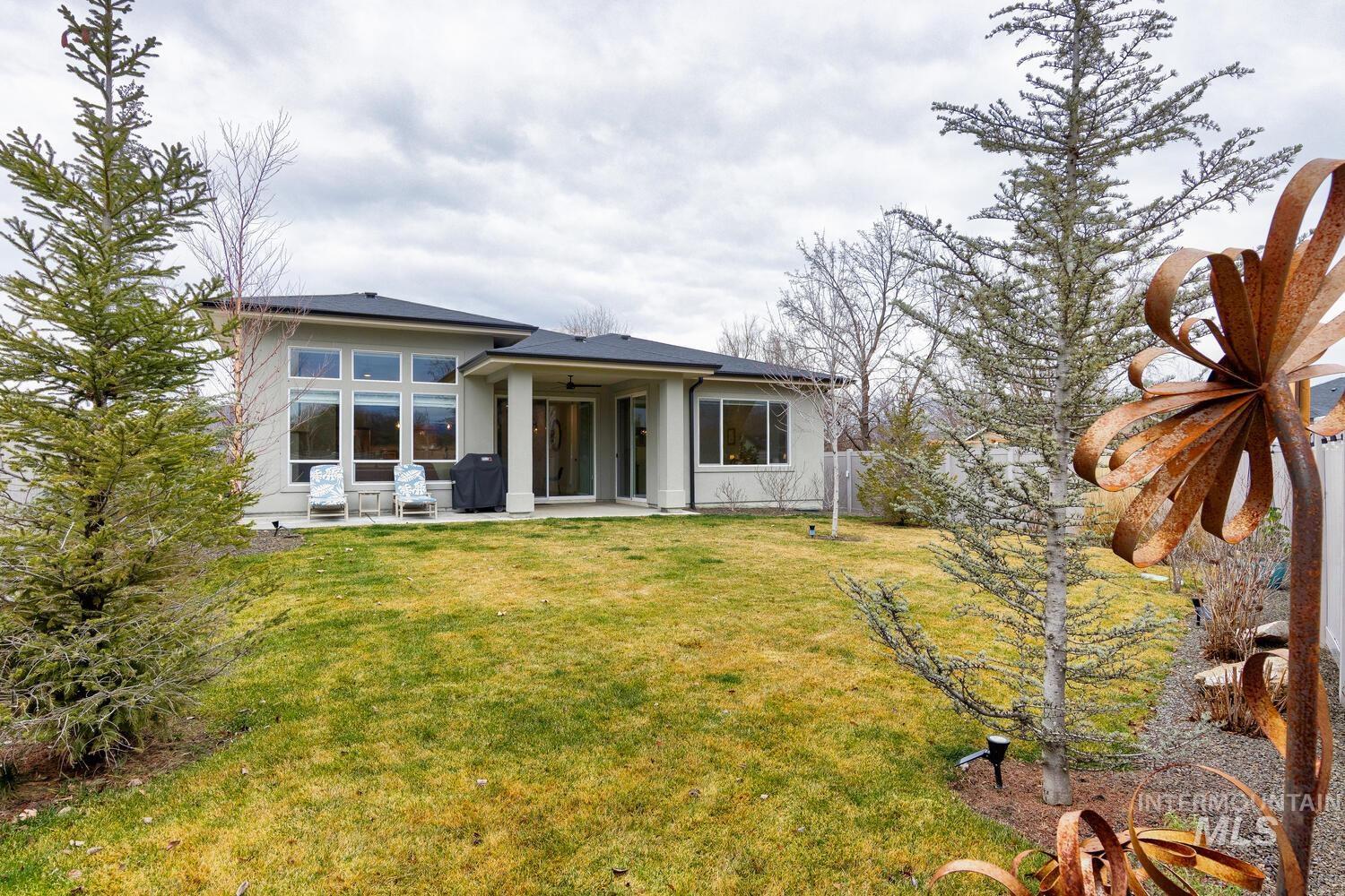 Back of house featuring a patio area and a ceiling fan