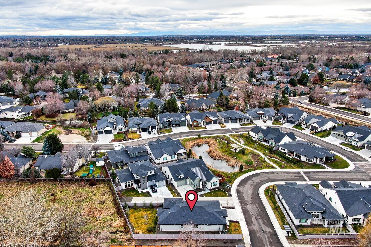 Aerial view of property's location featuring nearby suburban area and a nearby body of water