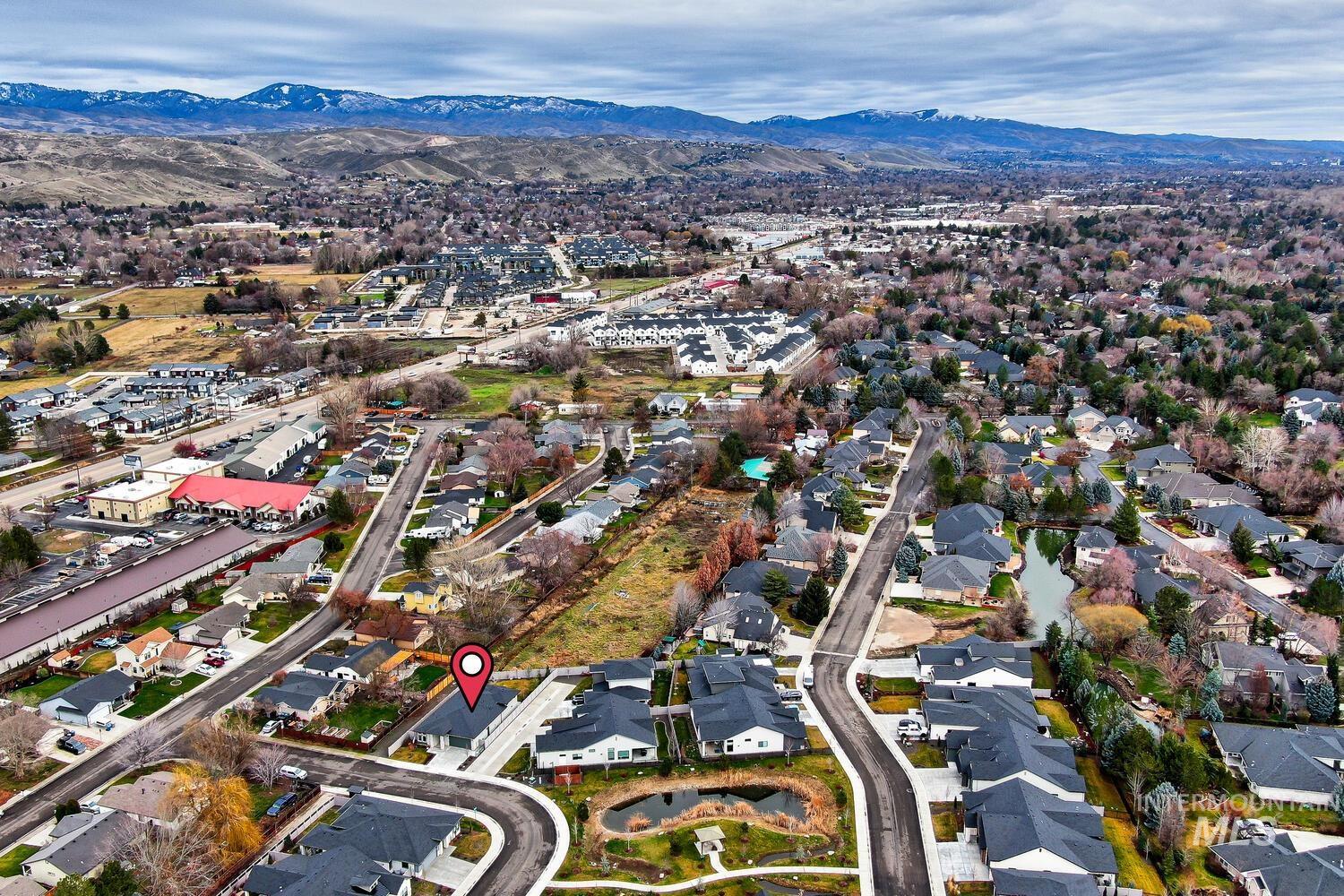 View of property location featuring a mountainous background and nearby suburban area