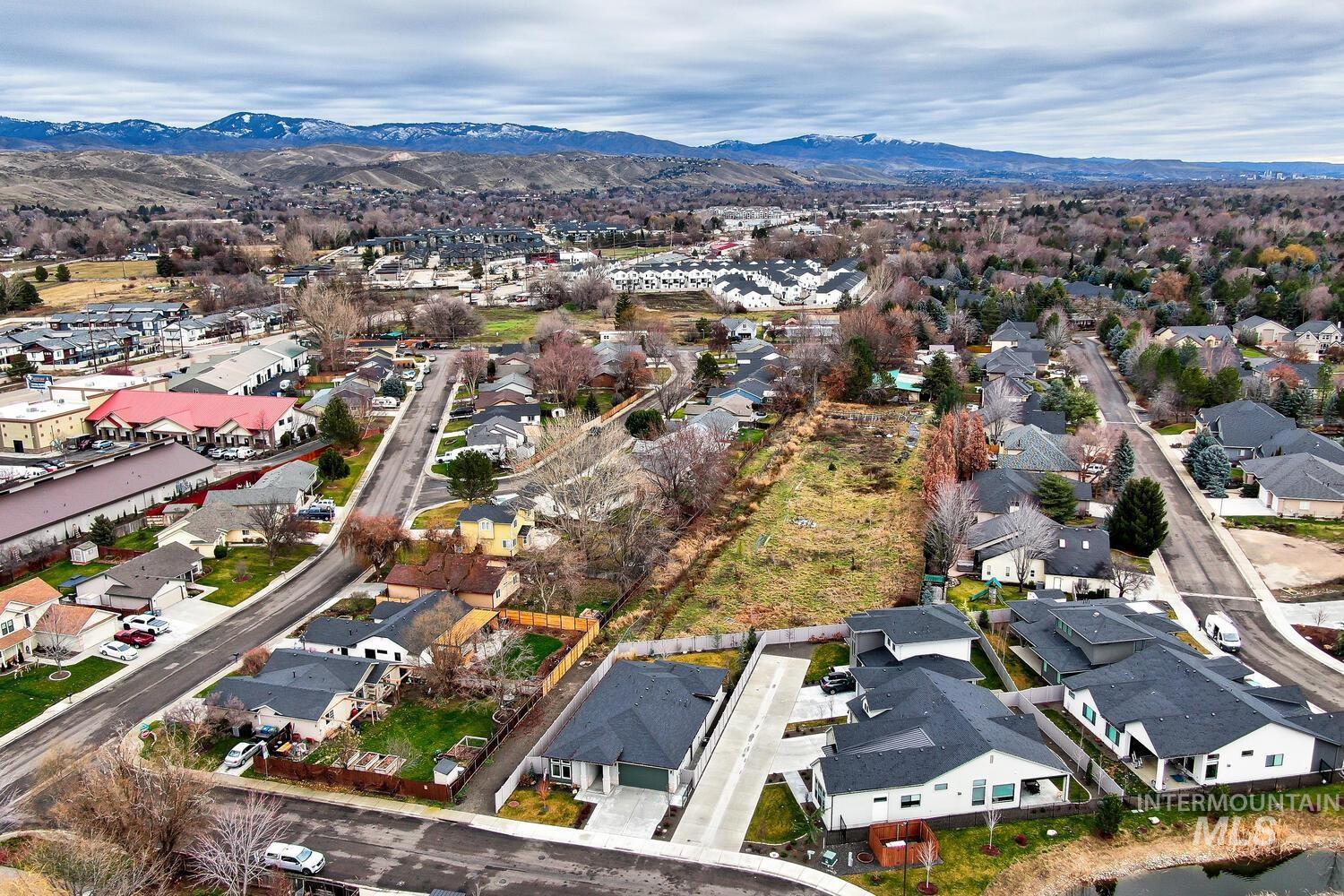 View of property location featuring nearby suburban area and a mountain backdrop