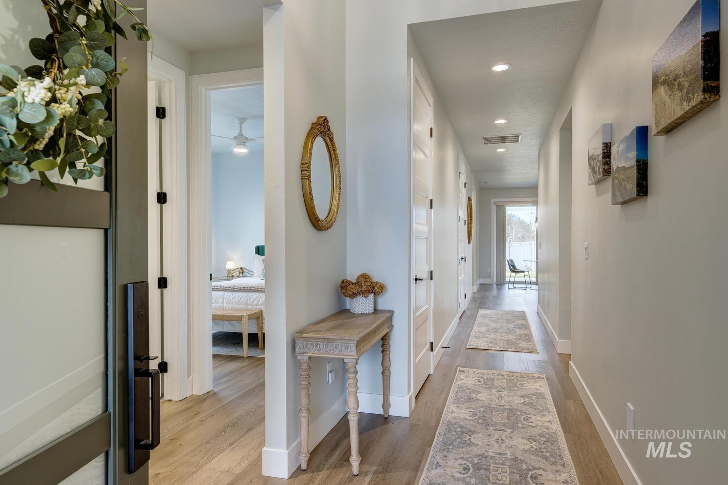 Hallway featuring light wood-style flooring and recessed lighting