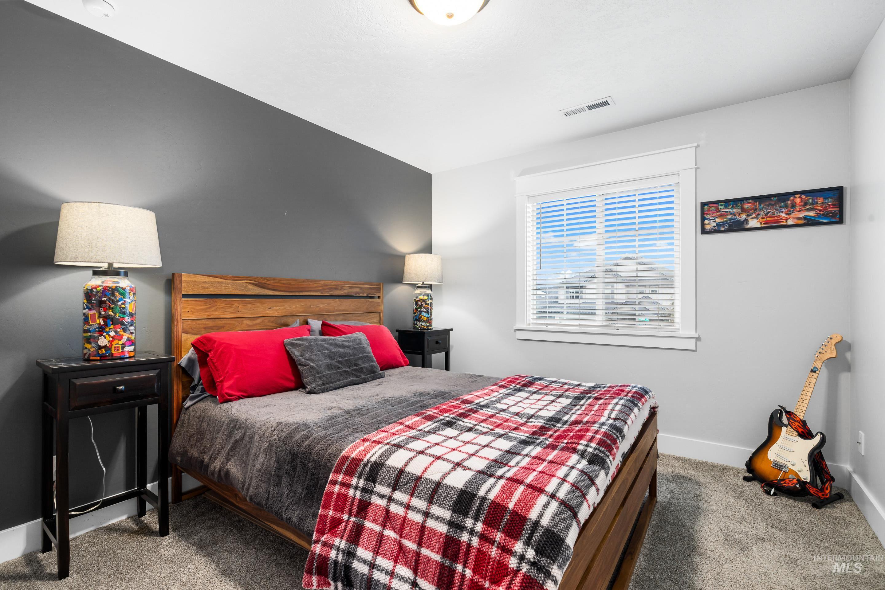 Bedroom with carpet floors and baseboards