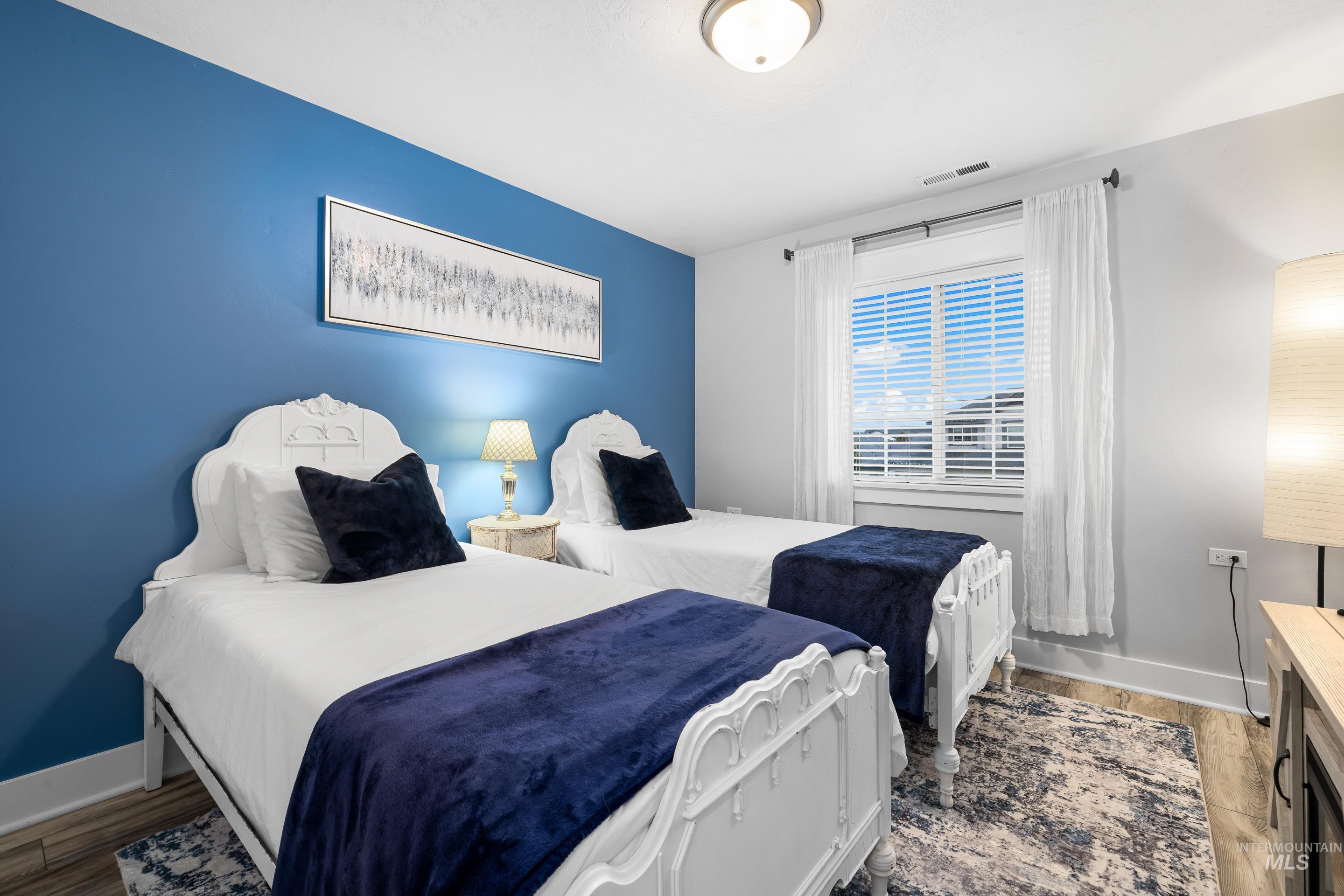 Bedroom with baseboards and light wood finished floors