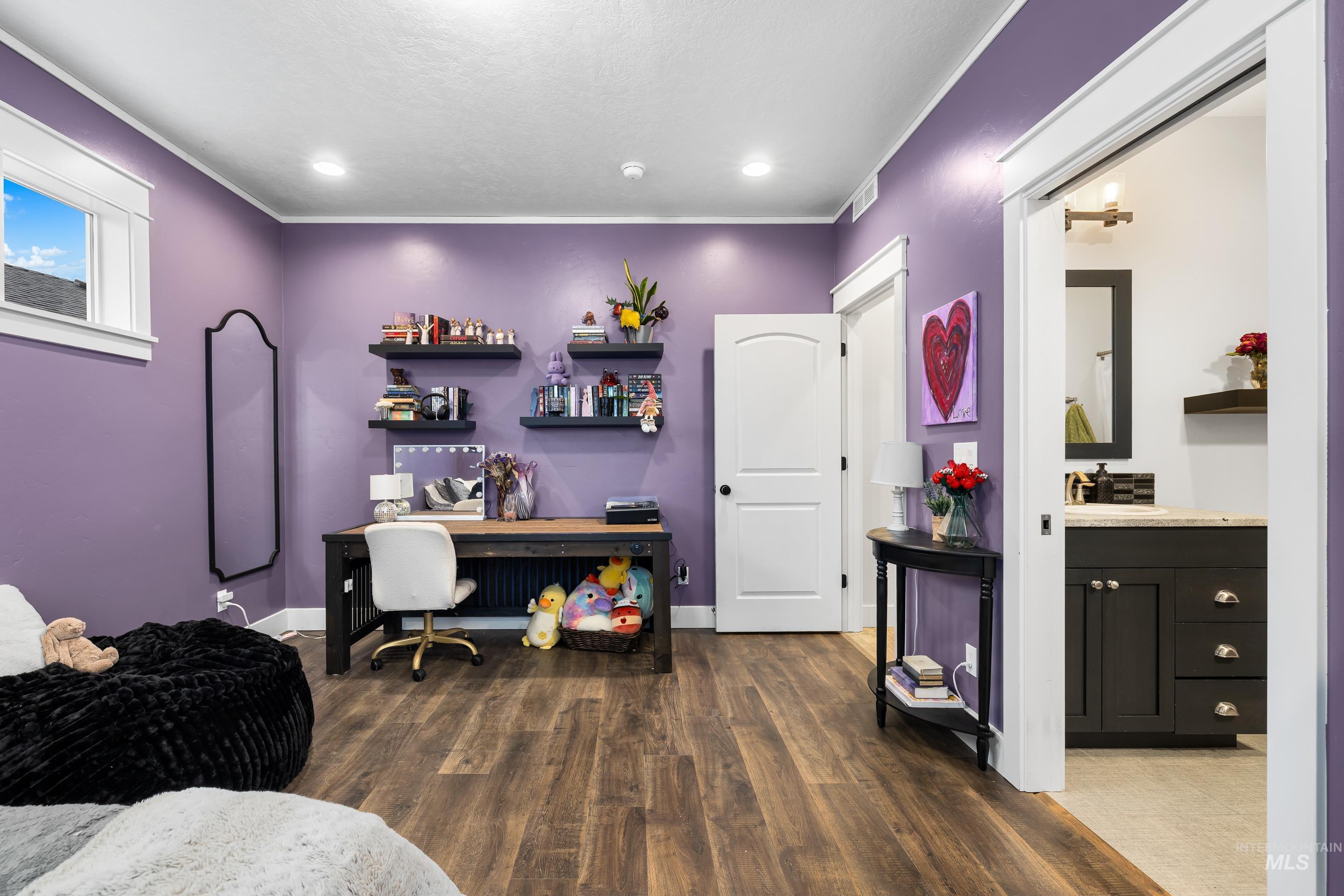 Home office featuring dark wood-style floors, ornamental molding, and recessed lighting