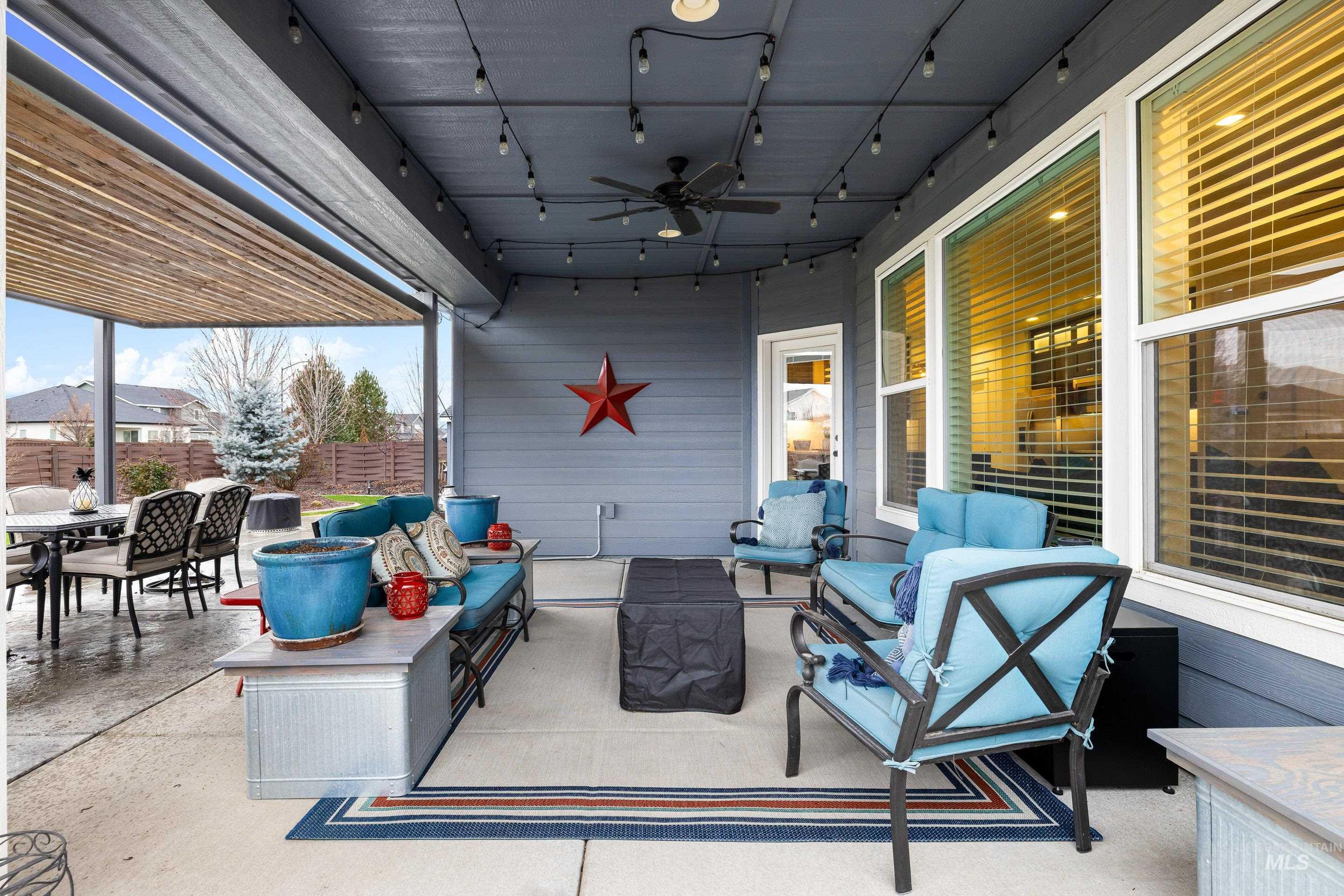 Fenced backyard with an outdoor living space, ceiling fan, a patio area, and outdoor dining area