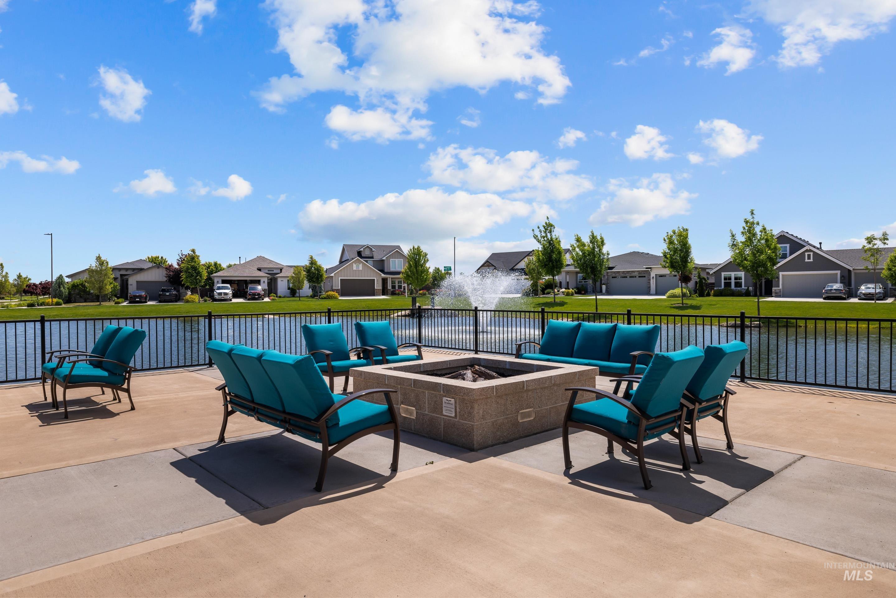 View of patio featuring an outdoor living space with a fire pit and a residential view