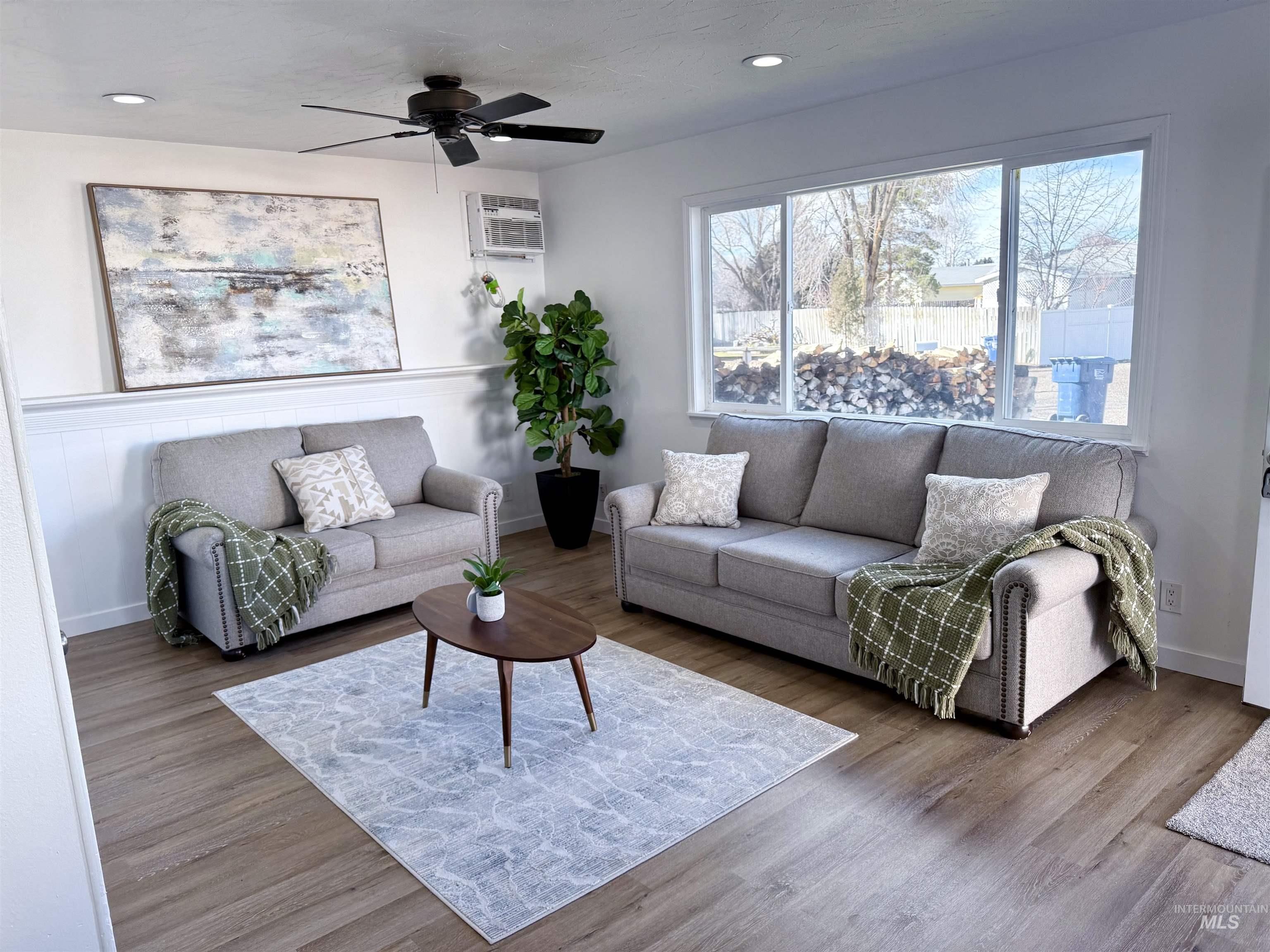 Living room featuring a ceiling fan, recessed lighting, and wood finished floors