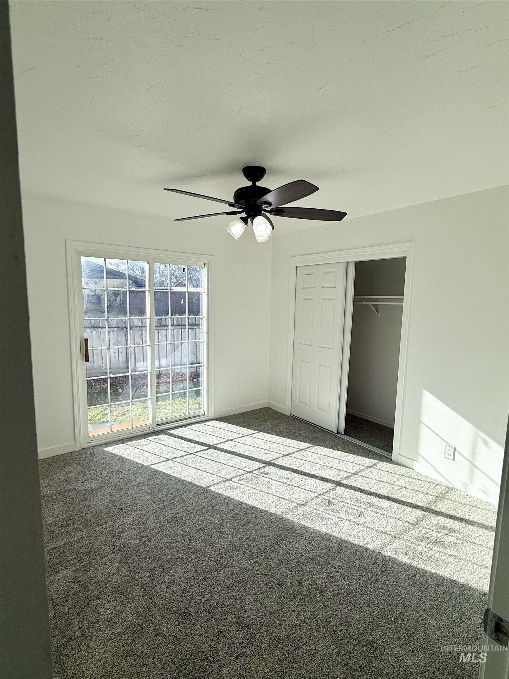 Unfurnished bedroom with carpet floors, a closet, and a ceiling fan
