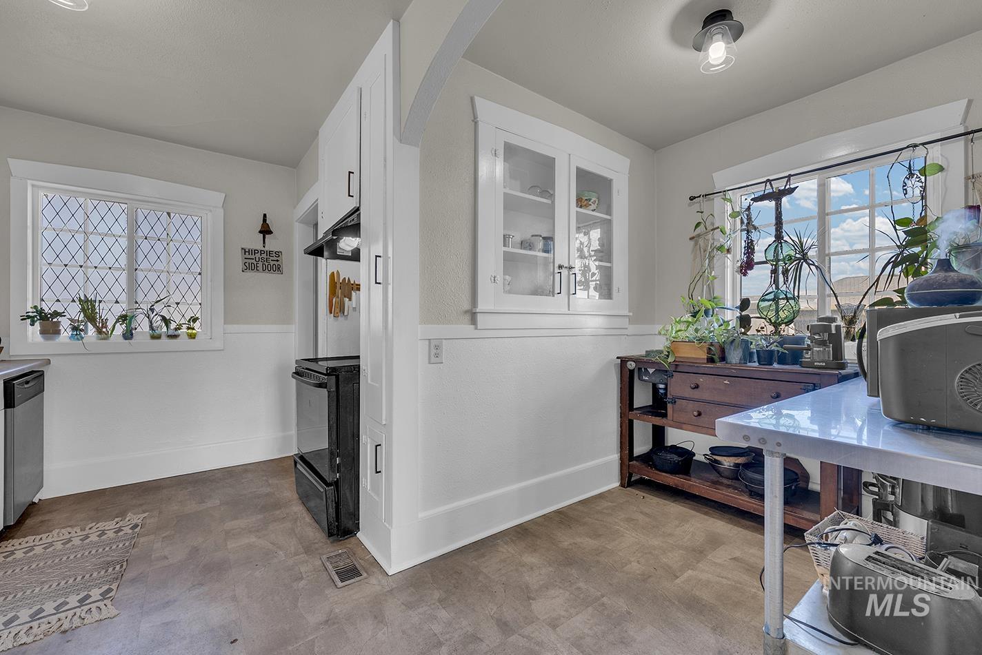 Interior space featuring baseboards and light flooring