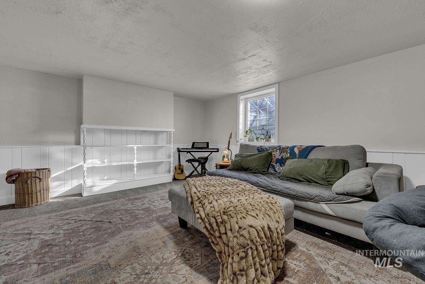 Living room with a textured ceiling and carpet