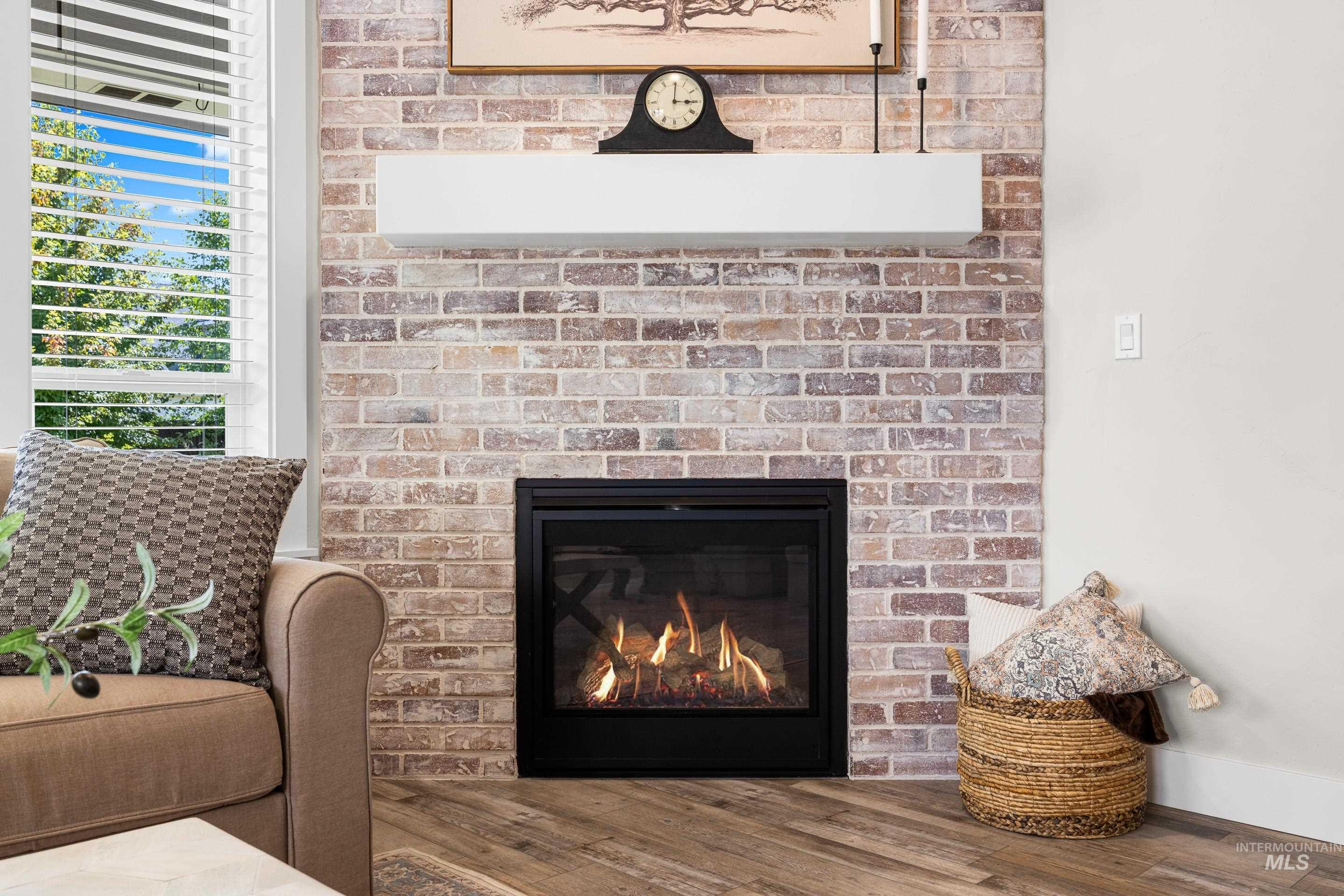 Detailed view of wood finished floors and a fireplace