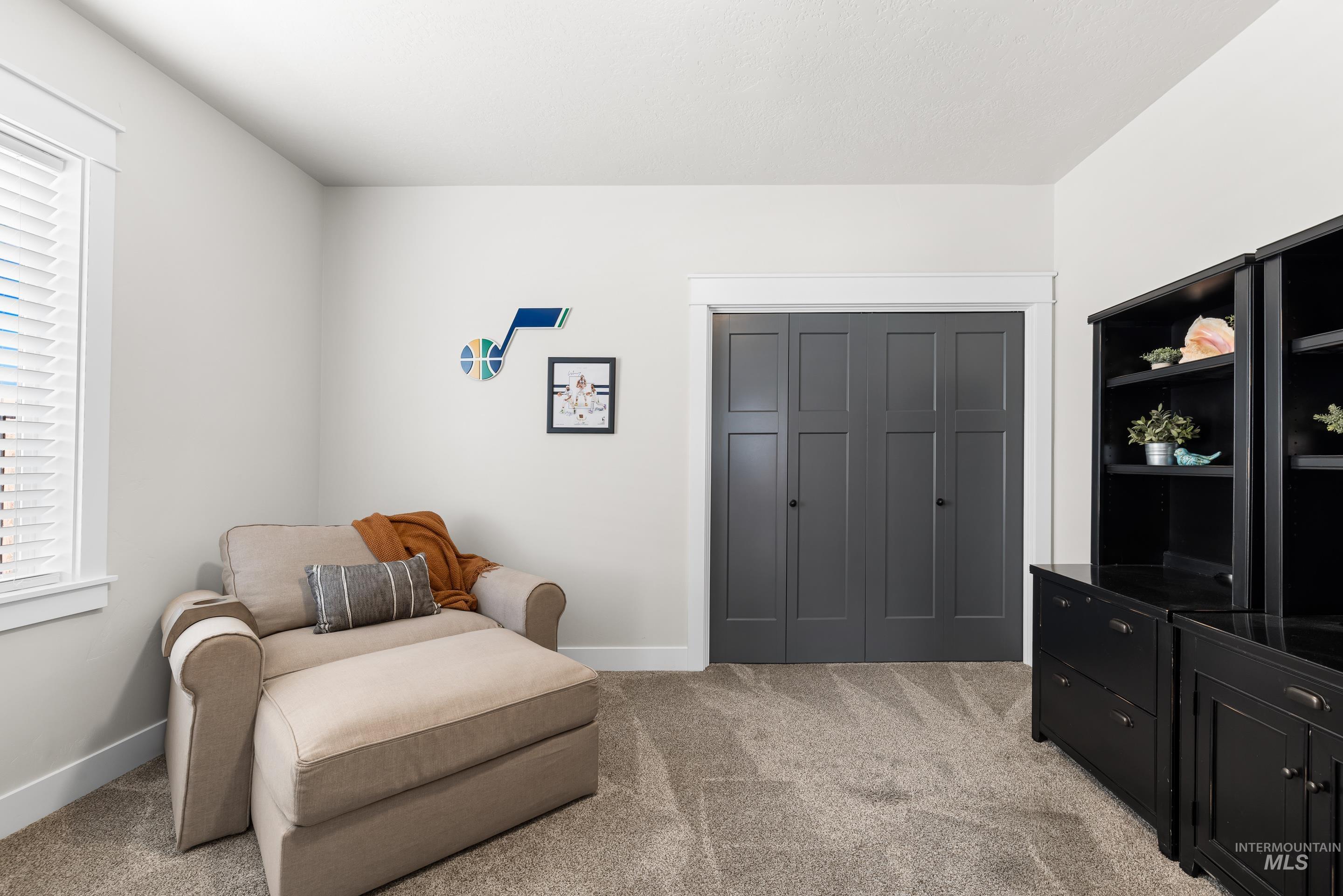 Living area featuring light colored carpet