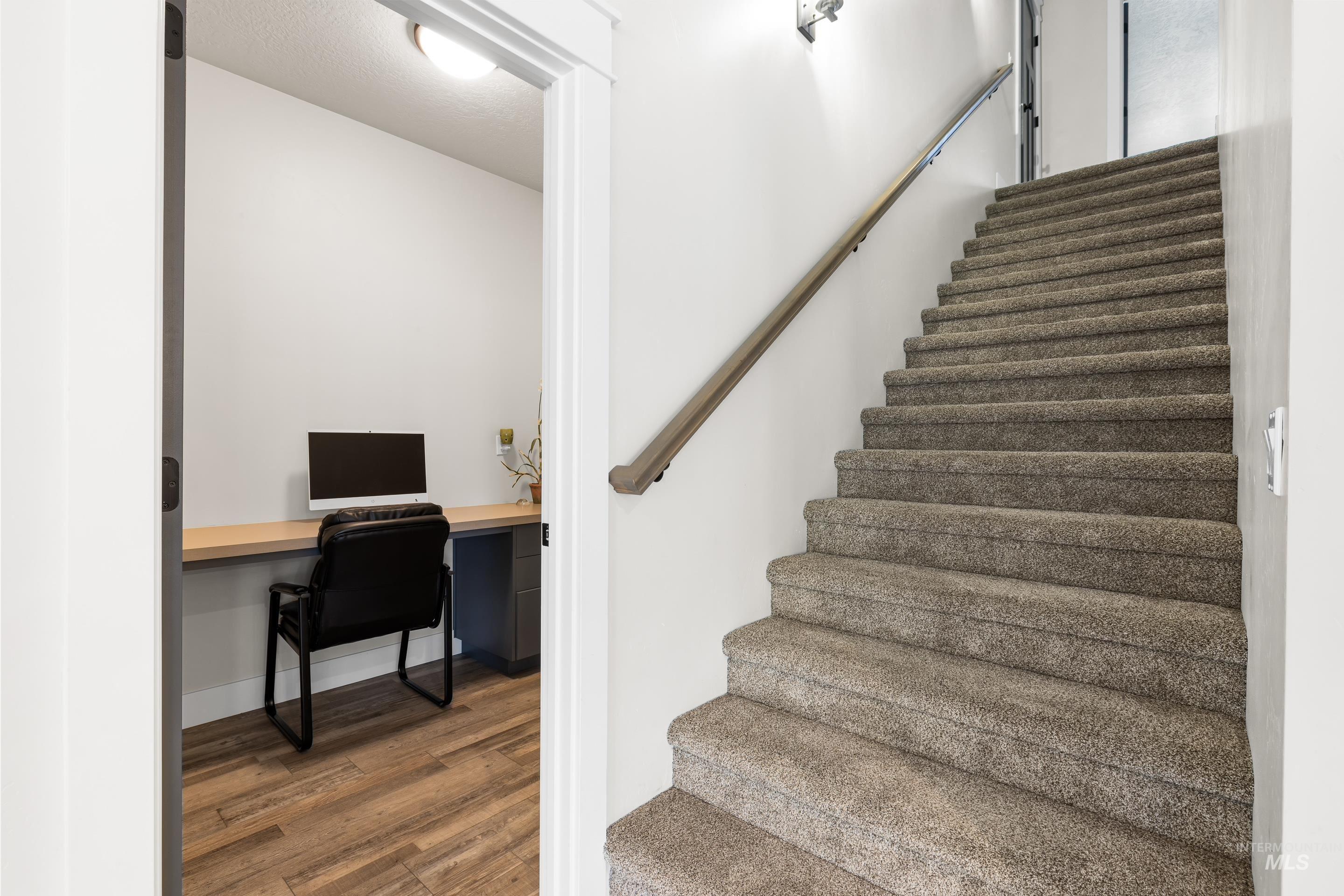 Staircase featuring wood finished floors