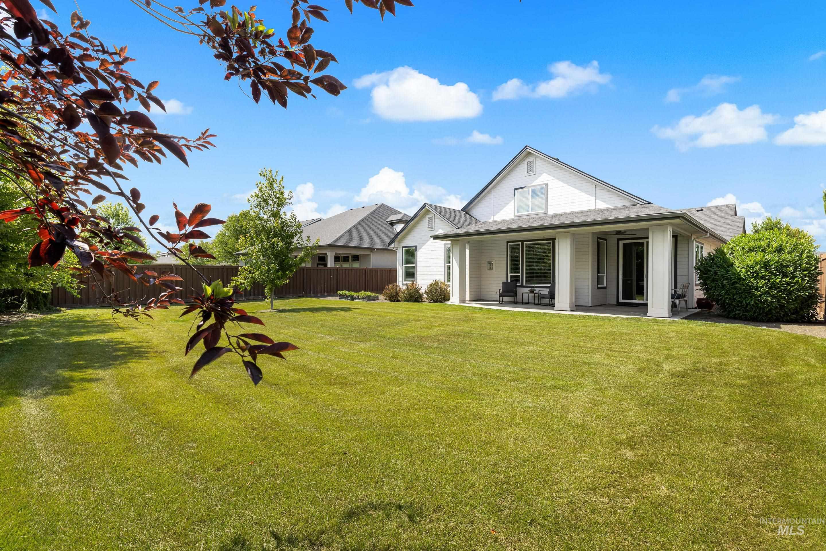 Back of property featuring a patio area and roof with shingles