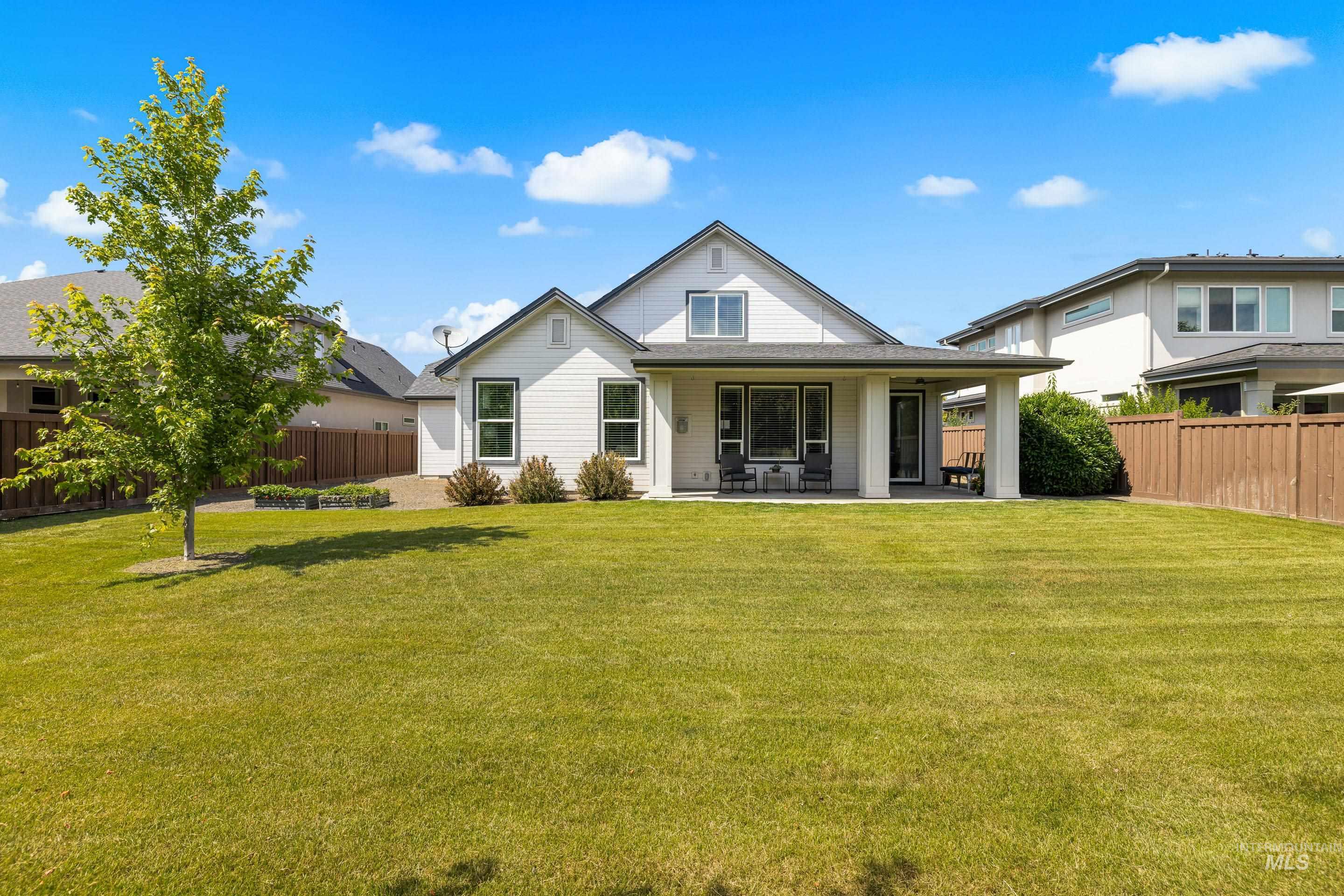 Back of property with a fenced backyard and a patio