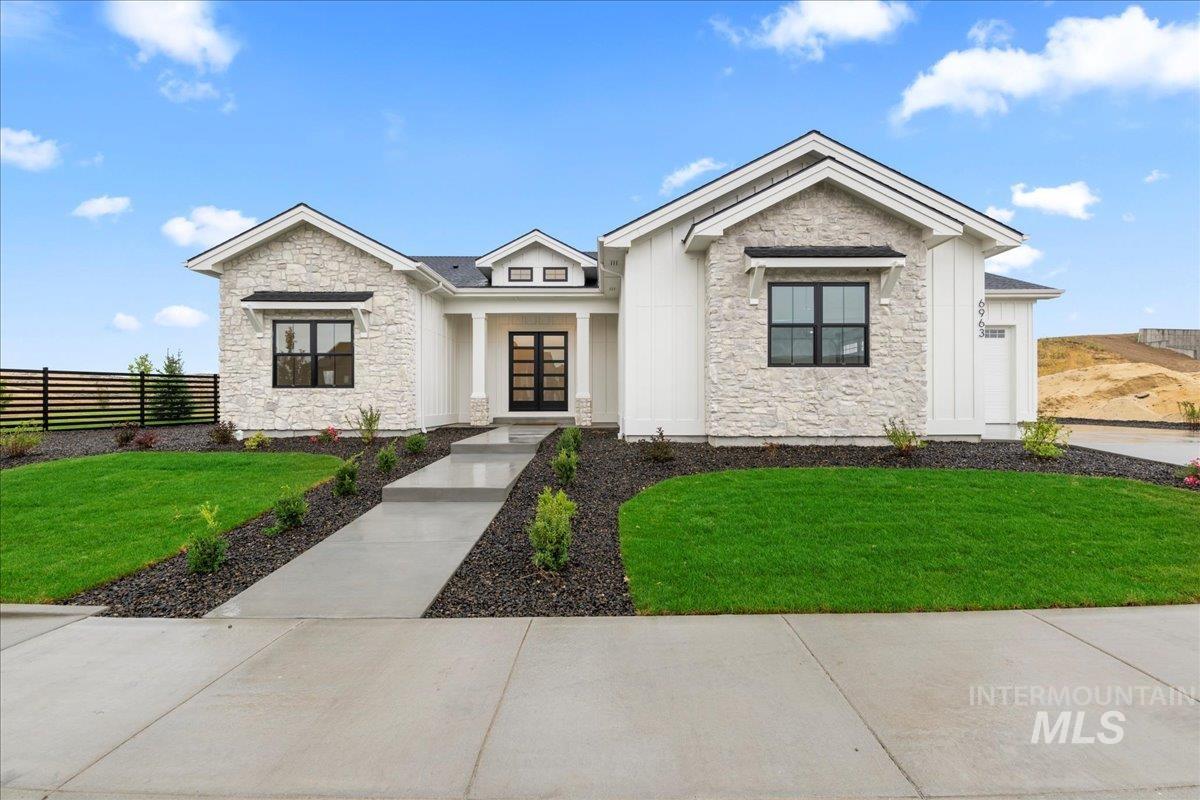 View of front facade featuring stone siding and board and batten siding