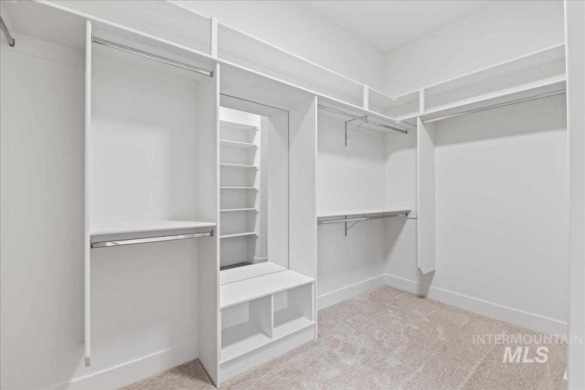 Spacious closet with light colored carpet