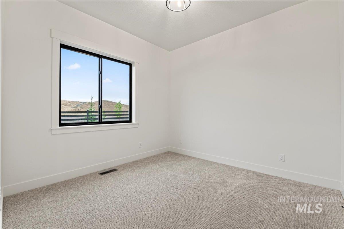 Spare room with baseboards and carpet flooring