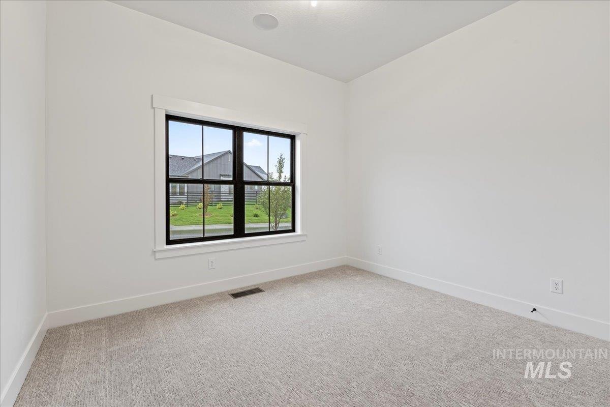 Unfurnished room with light colored carpet and baseboards
