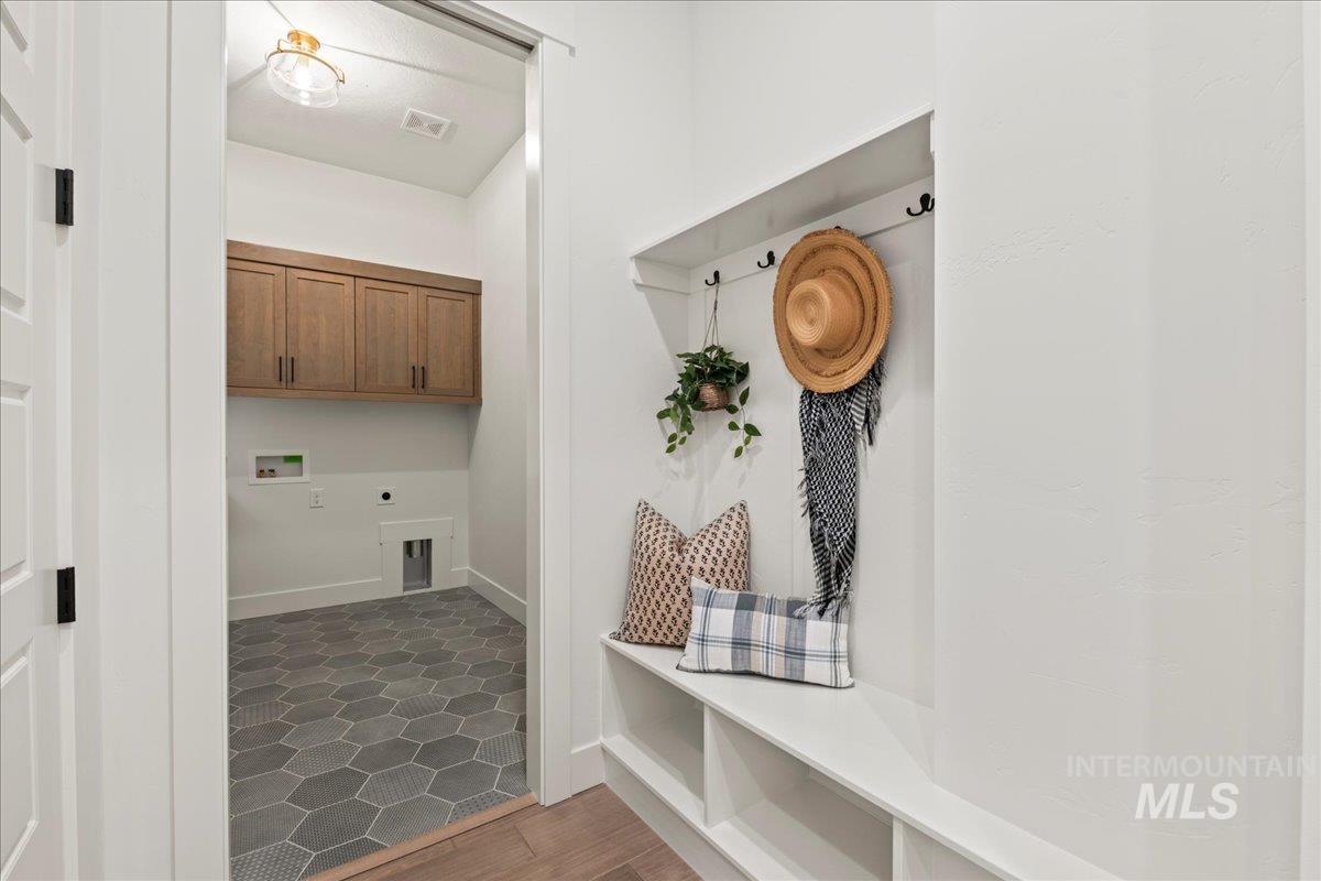 Mudroom featuring dark wood-type flooring and baseboards