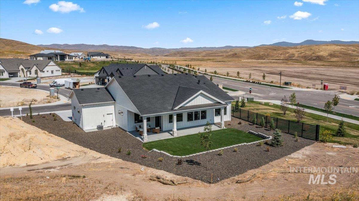 Aerial view of property and surrounding area with mountains