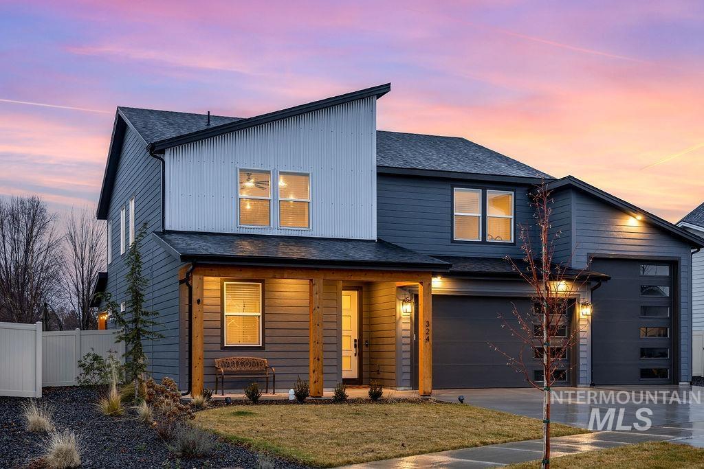 View of front of house featuring a shingled roof, driveway, covered porch, and board and batten siding