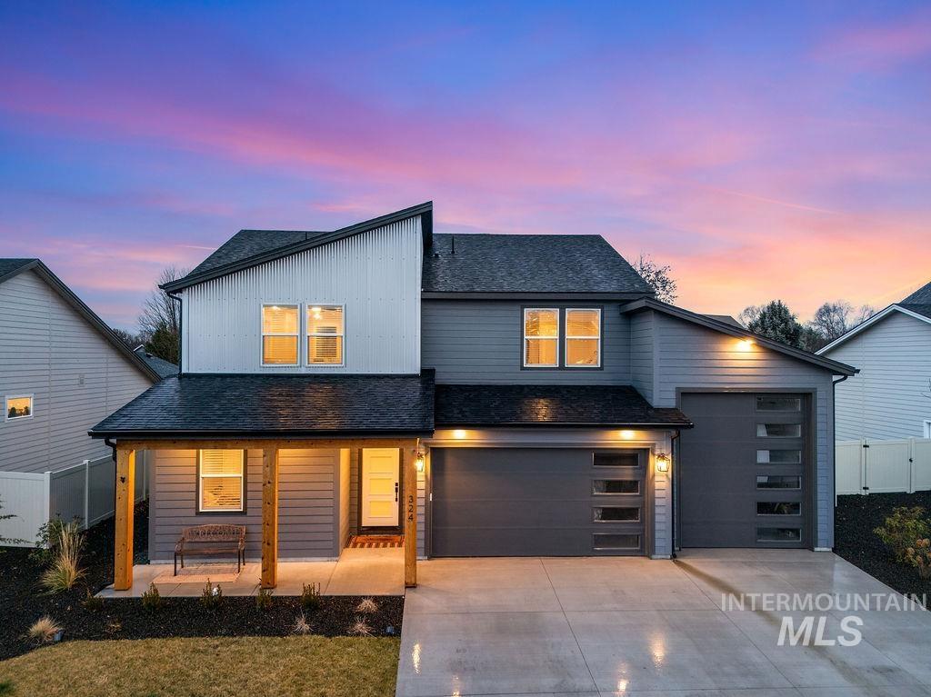 Contemporary home with roof with shingles, a porch, concrete driveway, an attached garage, and board and batten siding