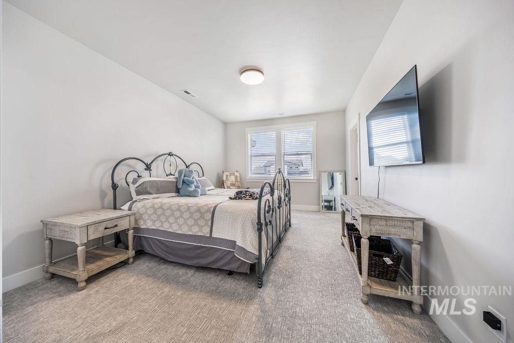 Carpeted bedroom featuring baseboards
