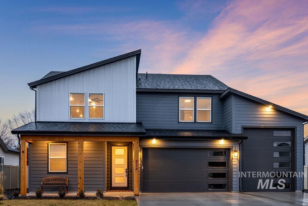 Contemporary house with a shingled roof, concrete driveway, covered porch, and a garage