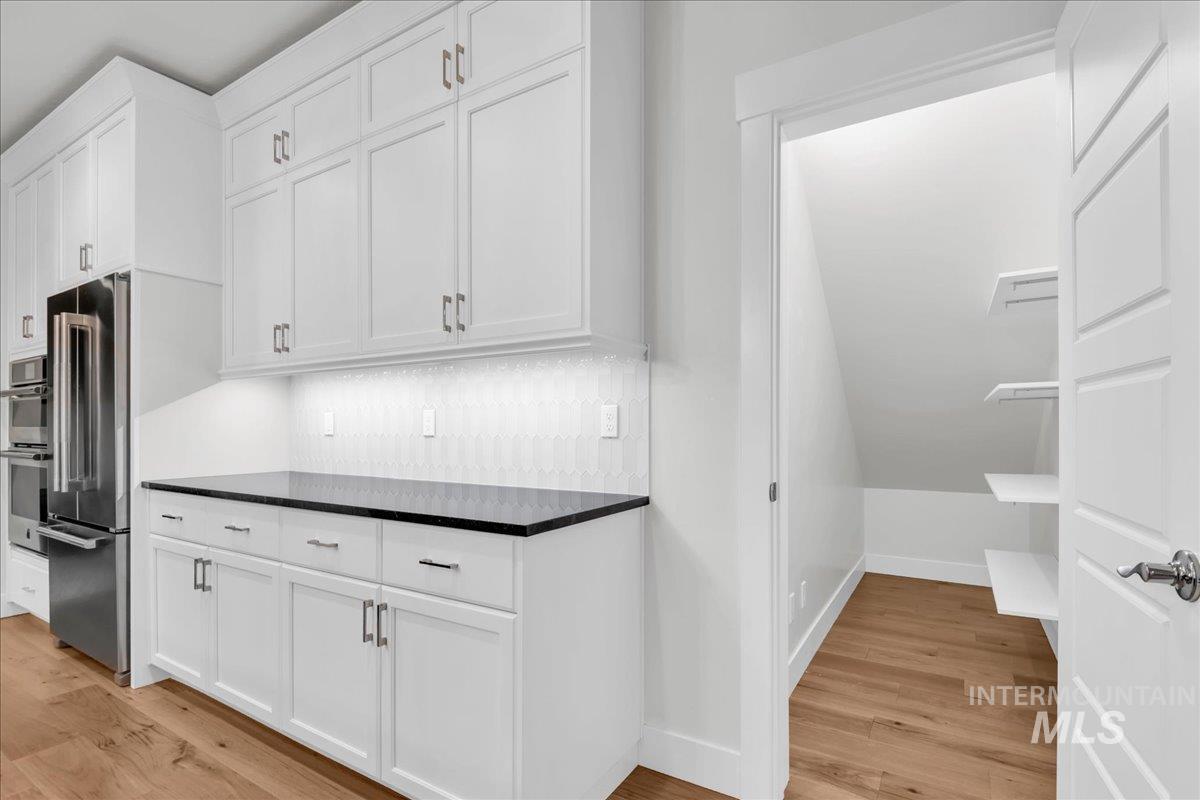 Kitchen with white cabinets and light wood-style flooring