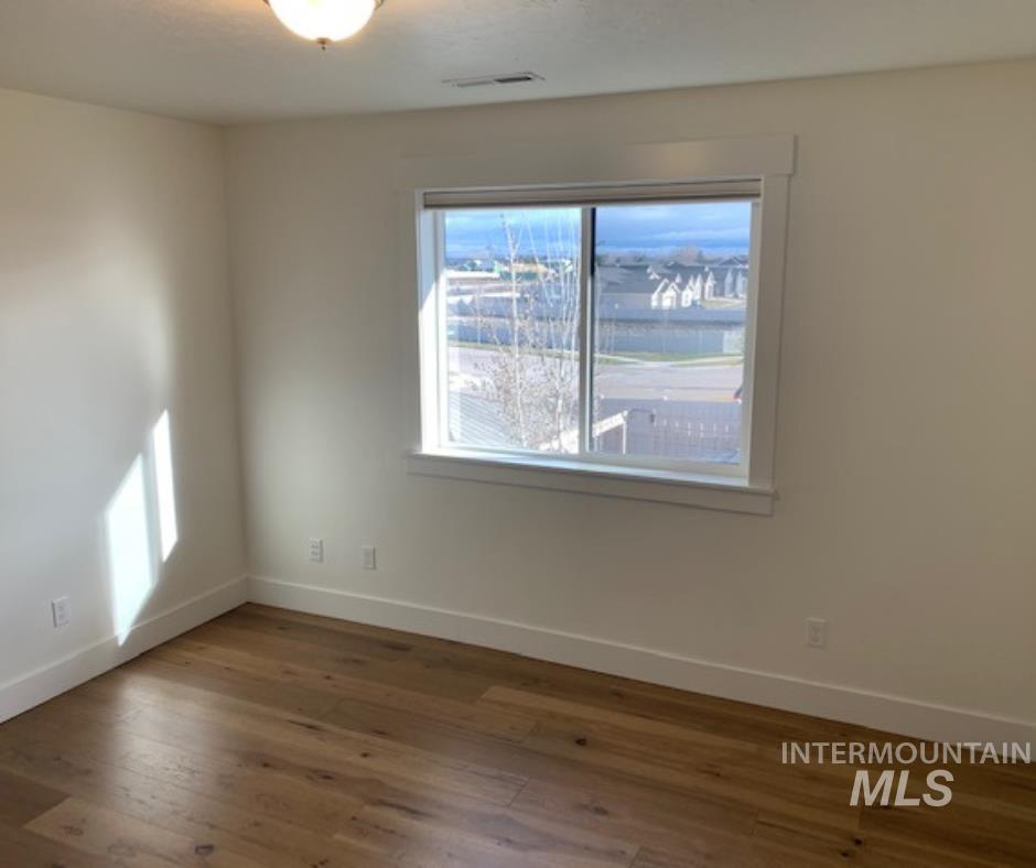 Empty room featuring a textured ceiling and light wood-style flooring